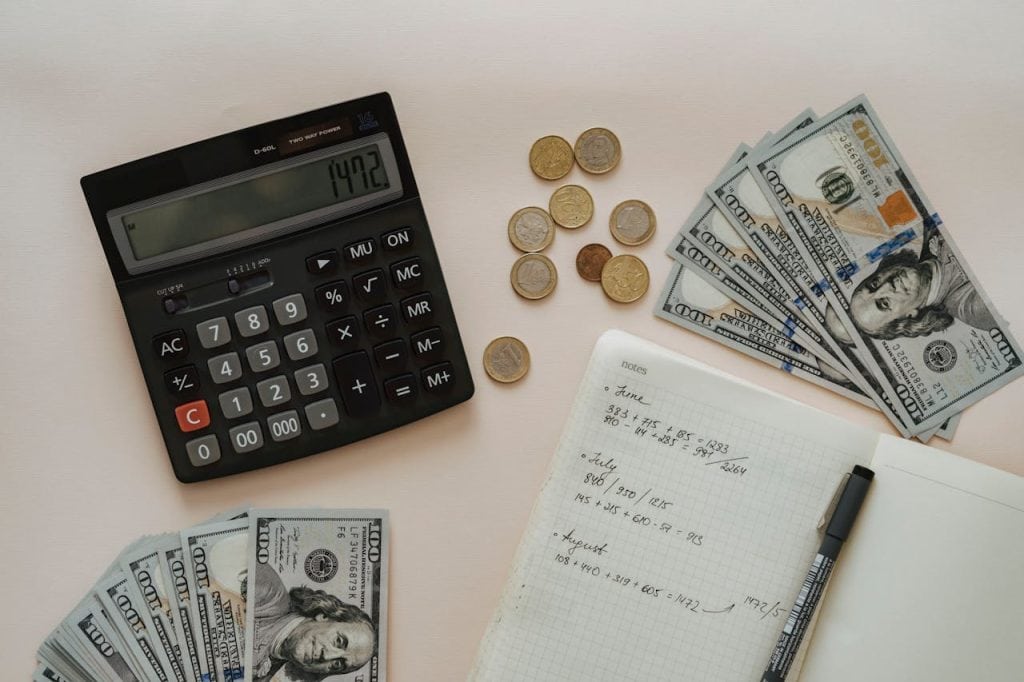 Financial Planning and Insurance Coverage Business financial planning with calculator, cash, and notes for insurance coverage.