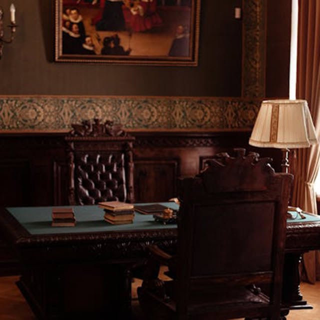 Office meeting room with vintage furniture and artwork.