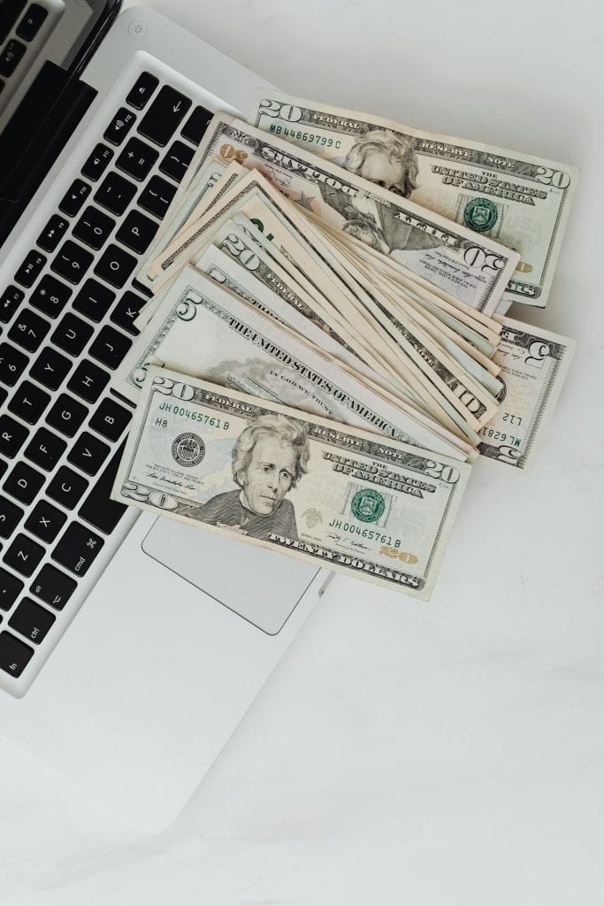 Financial planning with cash and laptop for insurance services. Financial planning with cash and laptop for insurance services.