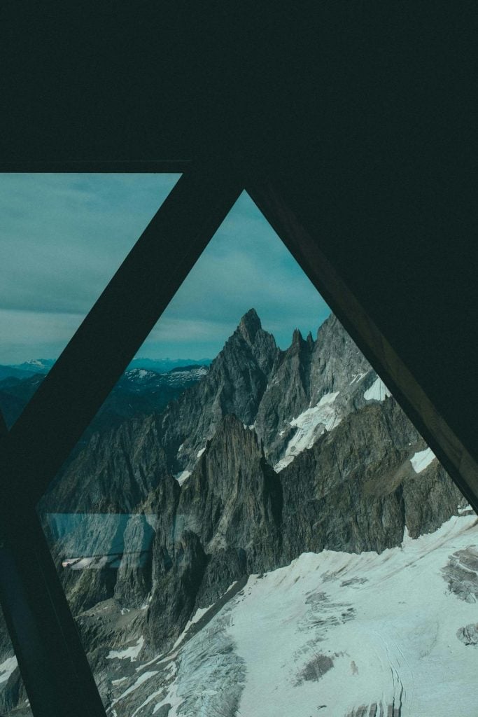 An image of a mountain seen through a glass A-frame An image of a mountain seen through a glass A-frame